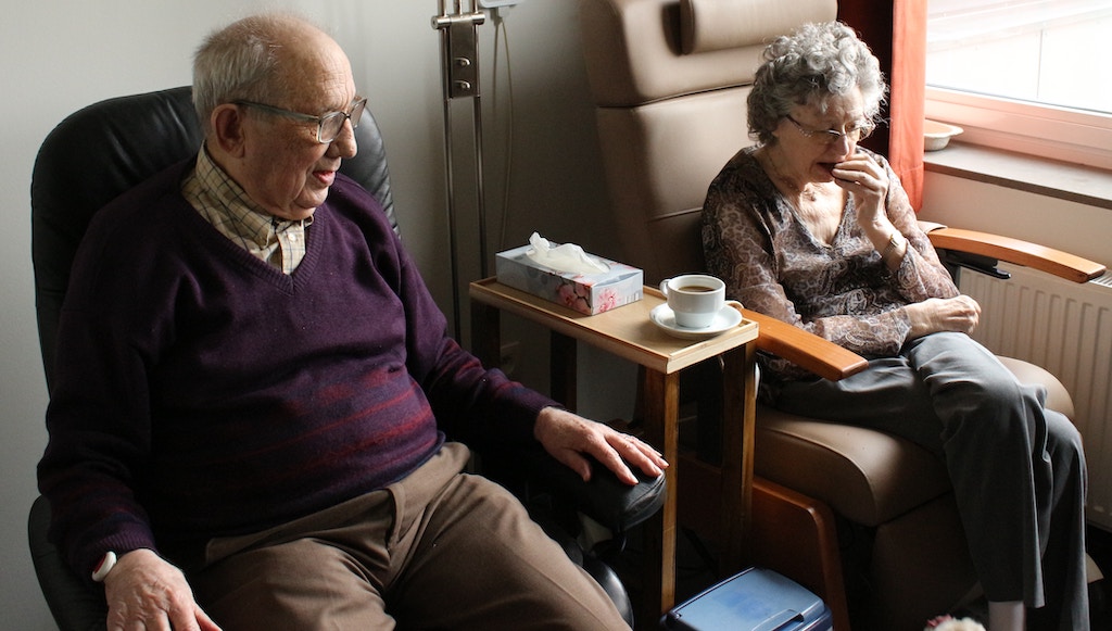 elderly couple sitting next to each other, signs you need assisted living