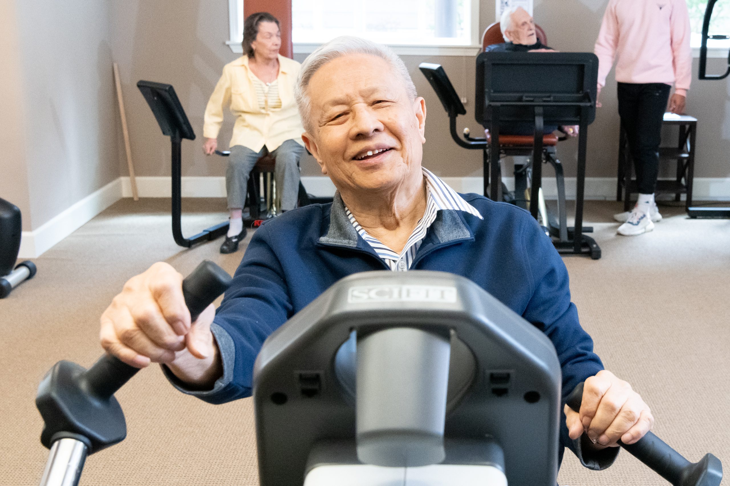 active senior enjoying working out in wellness center of laurel parc senior living community
